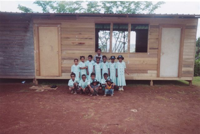 The children of Vesulogo in their new uniforms outside their new school.